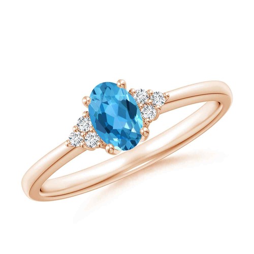 ANGARA 0.6 Ct Solitaire Oval Swiss Blue Topaz Ring with Trio Diamond in 14K Gold
