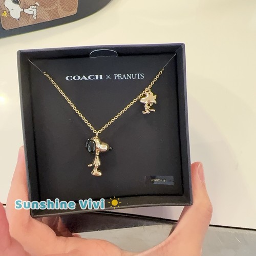 Collana con ciondolo Coach X Peanuts Snoopy e Woodstock CCA48 oro nero nuova con etichette